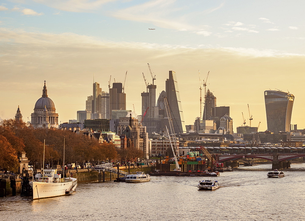 View over River Thames towards City of London at sunrise, London, England, United Kingdom, Europe