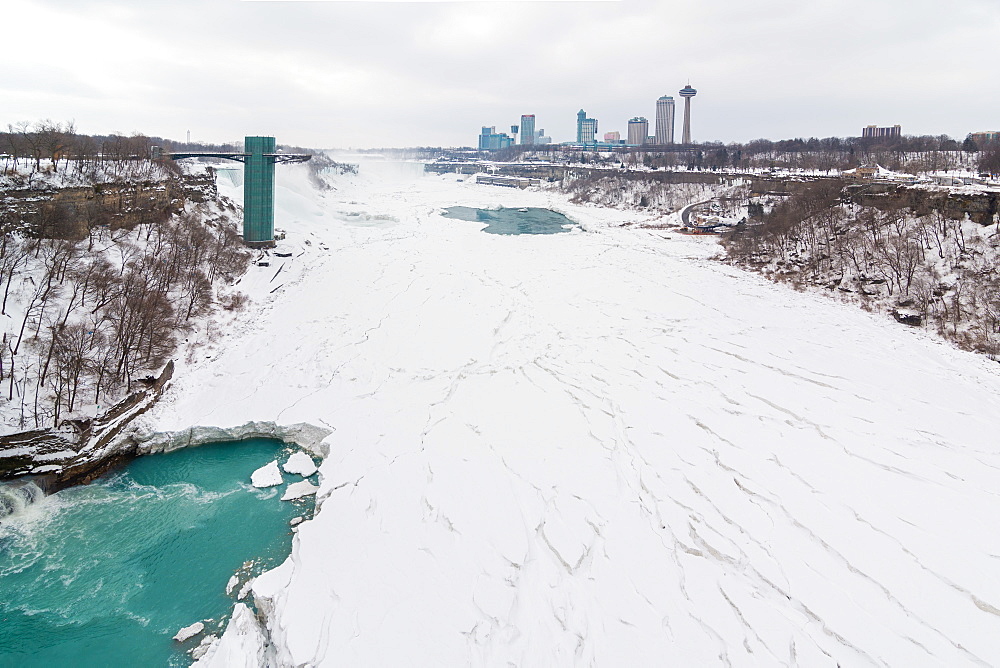 Frozen Niagara Falls in March, view from the bridge between Canada and United States of America. Ontario, Canada, North America