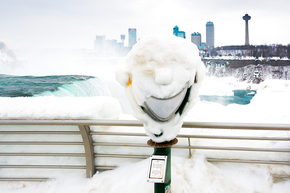 Frozen smile on coin operated binoculars covered in ice at Niagara Falls, Buffalo, New York State, United States of America, North America