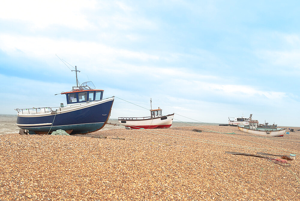 Fishing boats on the shingle beach waiting to go back out to the water, Dungeness, Kent, England, United Kingdom, Europe