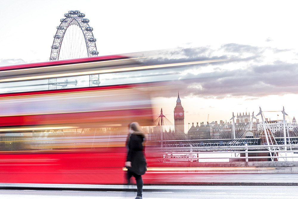 A lady crossing Waterloo Bridge with a bus passing between her, the London Eye and Big Ben, London, England, United Kingdom, Europe