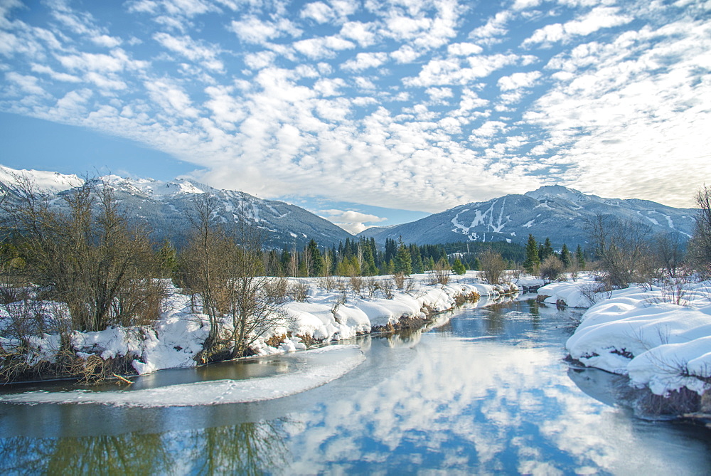 White clouds reflect over the River of Golden Dreams in Whistler, British Columbia, Canada, North America