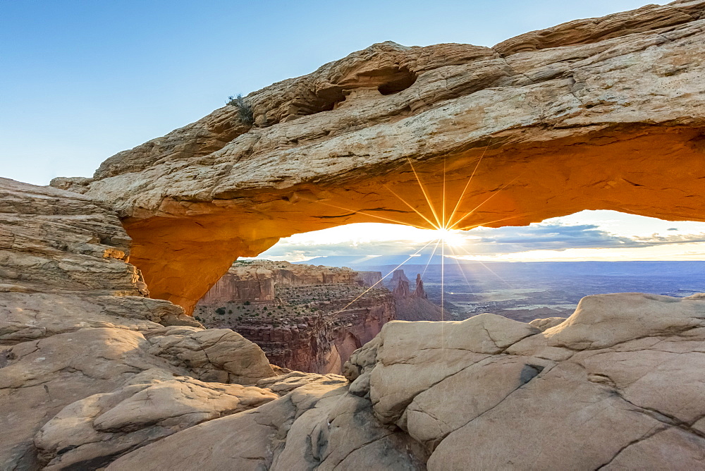 The sun is rising under Mesa Arch, Canyonlands National Park, Moab, Utah, United States of America, North America