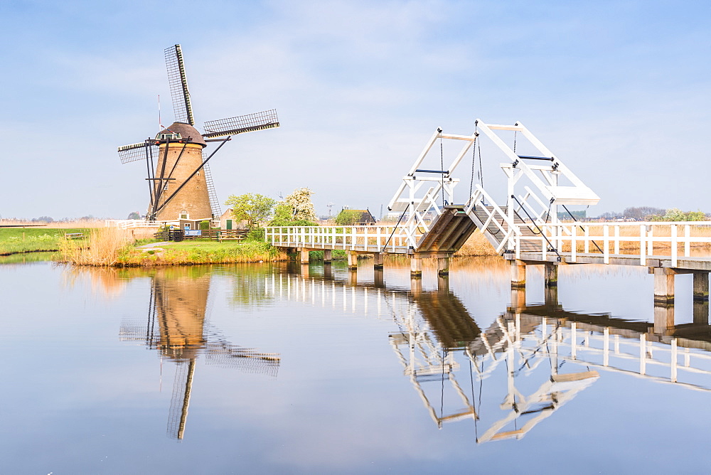 Windmill and sluice on the canal, Kinderdijk, UNESCO World Heritage Site, Molenwaard municipality, South Holland province, Netherlands, Europe