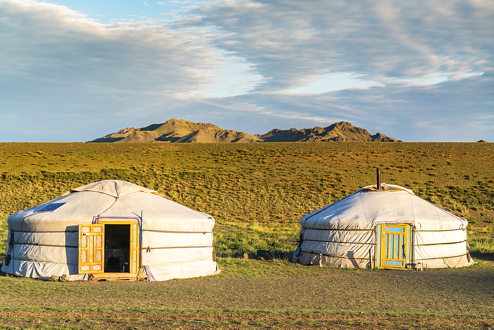 Two Mongolian nomadic gers and mountains in the background, Bayandalai district, South Gobi province, Mongolia, Central Asia, Asia