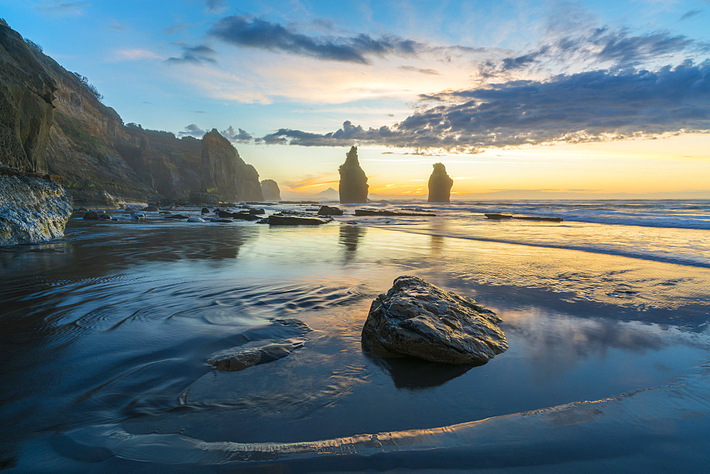 Reflection of the Three Sisters with low tide, at sunset, Tongaporutu, New Plymouth district, Taranaki region, North Island, New Zealand, Pacific