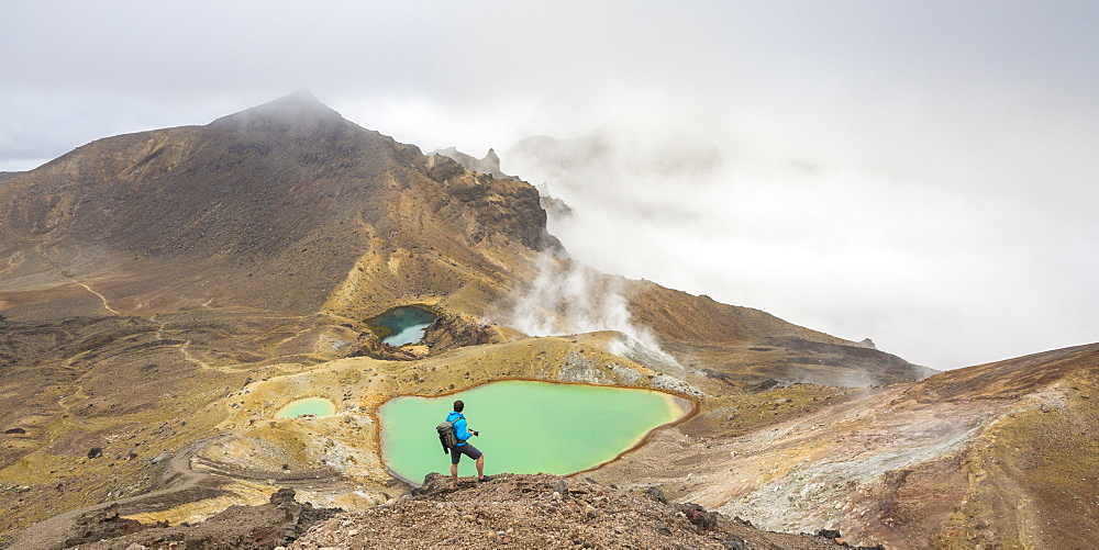 Man taking photos of Emerald Lakes, Tongariro Alpine Crossing, Tongariro National Park, UNESCO World Heritage Site, Waikato region, North Island, New Zealand, Pacific