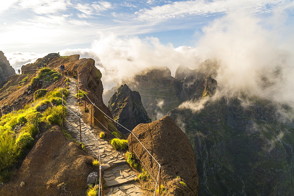 Hikers walking on Vereda do Areeiro, the trail that links Pico Ruivo to Pico do Arieiro, Funchal, Madeira, Portugal, Atlantic, Europe