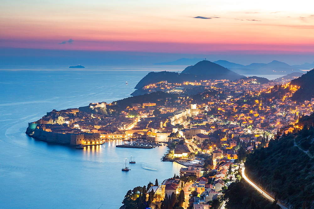 The city lights at sunset over the old town of Dubrovnik, UNESCO World Heritage Site, and the Dalmatian Coast, Croatia, Europe