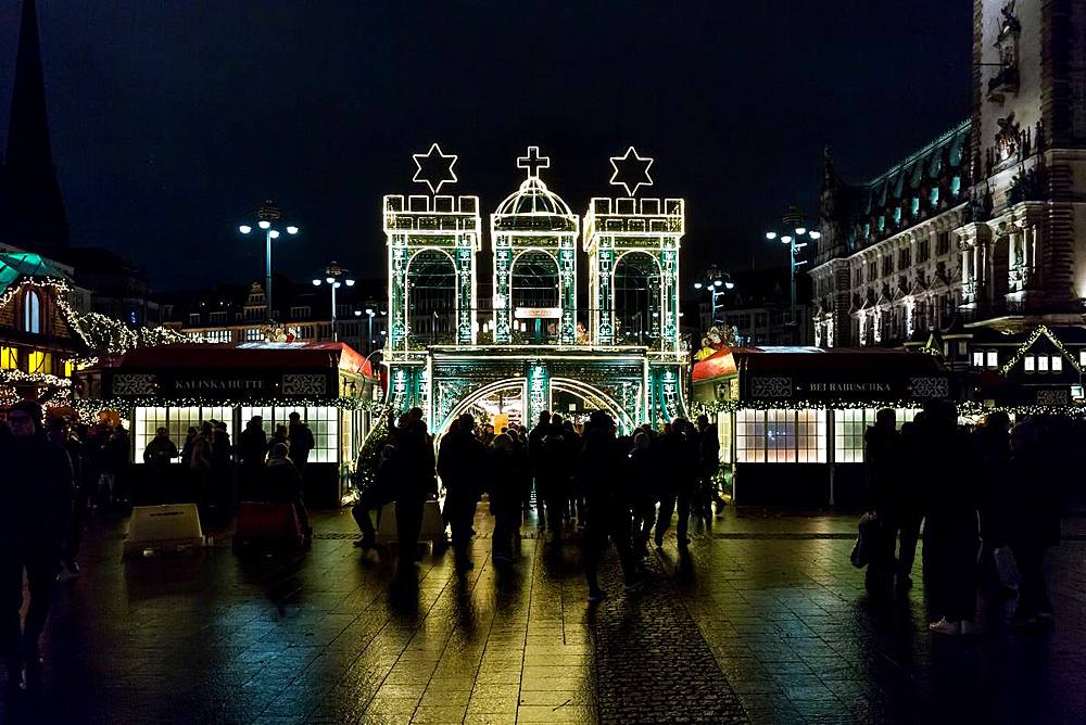 The entrance to Hamburg's Rathaus Christmas Market (Weihnachtsmarkt Rathausmarkt) at night, Hamburg, Germany, Europe