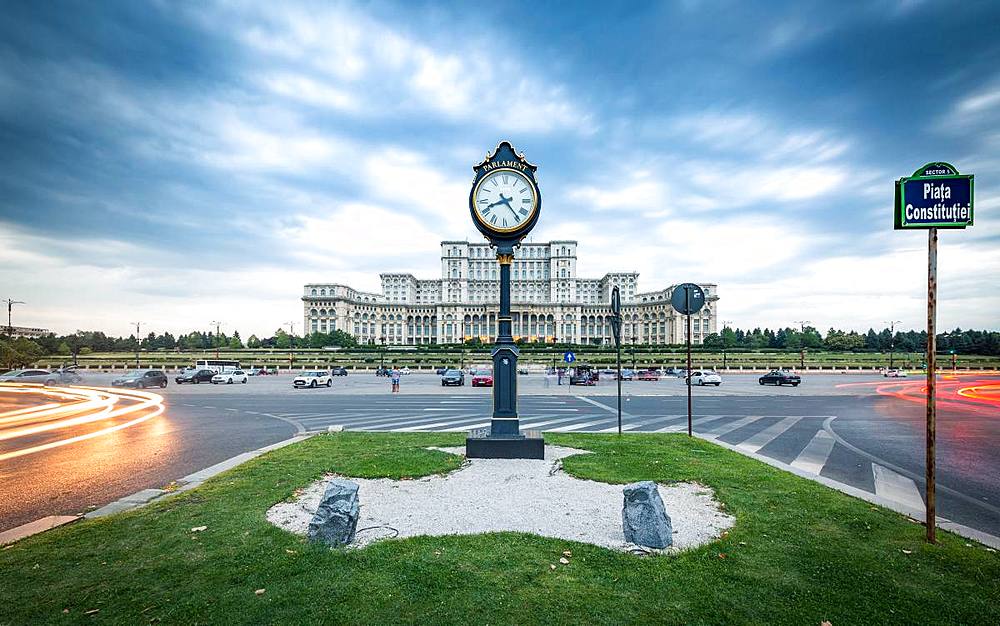 Car light trails at blue hour in front of the huge Palace of Parliament (Palatul Parlamentului), Bucharest, Romania, Europe