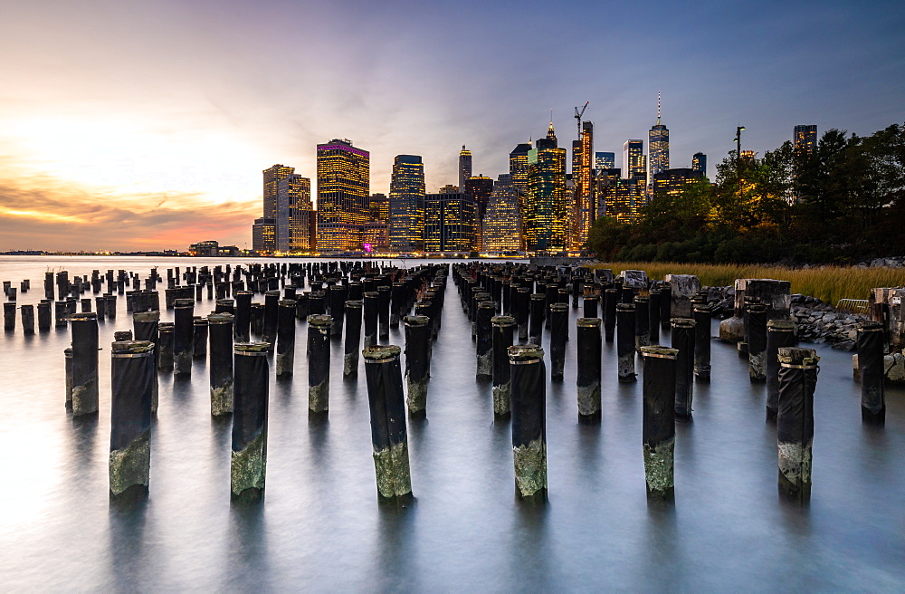 Long exposure of the lights of Lower Manhattan during sunset as seen from Brooklyn Bridge Park, New York, United States of America, North America