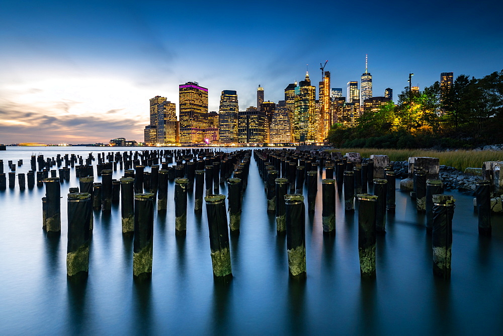 Long exposure of the lights of Lower Manhattan during the evening blue hour as seen from Brooklyn Bridge Park, New York, United States of America, North America