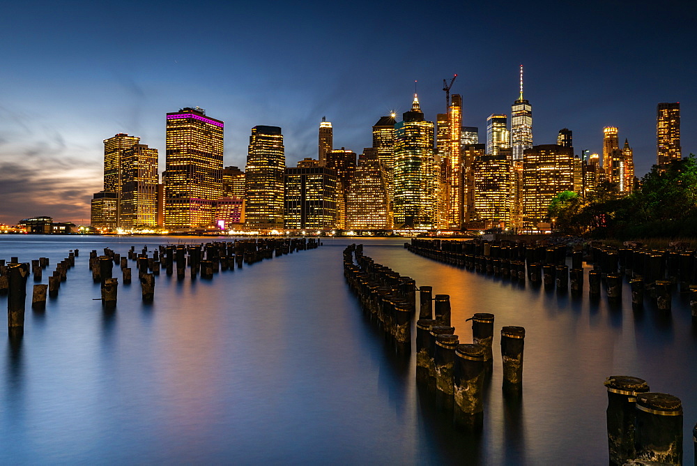 Long exposure of the lights of Lower Manhattan during the evening blue hour as seen from Brooklyn Bridge Park, New York, United States of America, North America