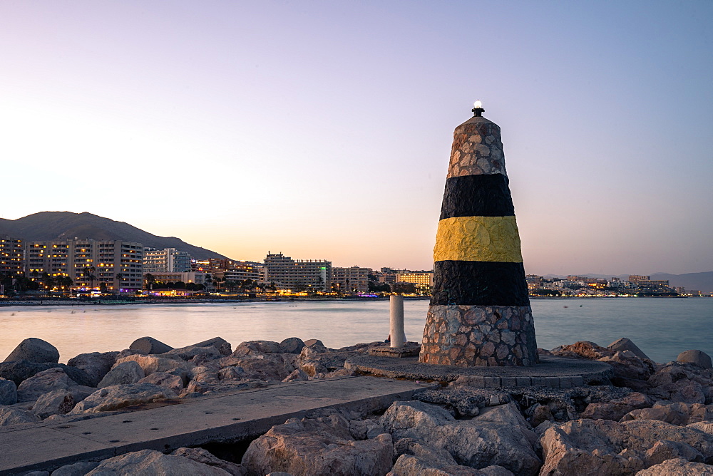 Faro de Levante lighthouse at Benalmadena Puerto Marina at sunset, Costa Del Sol, Andalusia, Spain, Europe