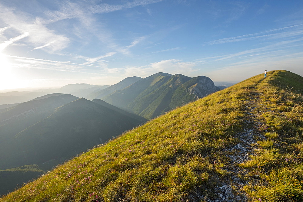 Young hiker on the summit of Mont Motette, Apennines, Umbria, Italy, Europe