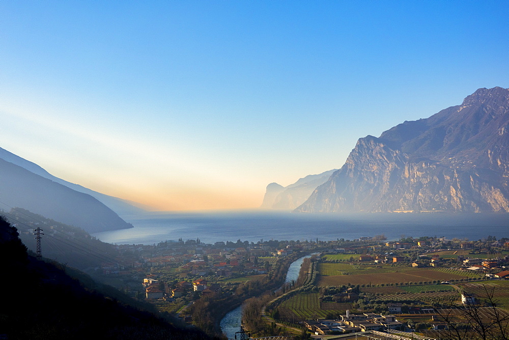 Riva del Garda at sunrise in winter, Lake Garda, Trentino, Dolomites, Italy, Europe