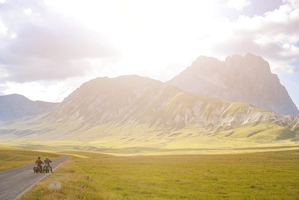 Bikers in plateau Campo Imperatore at sunset, Gran Sasso e Monti della Laga National Park, Abruzzo, Italy, Europe