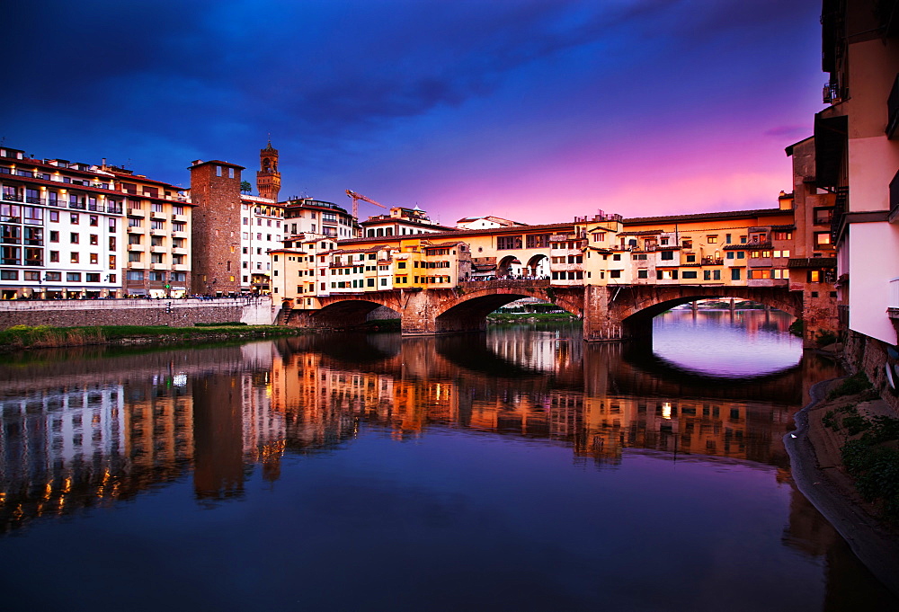 Ponte Vecchio at sunset reflecting in River Arno, Florence, UNESCO World Heritage Site, Tuscany, Italy, Europe