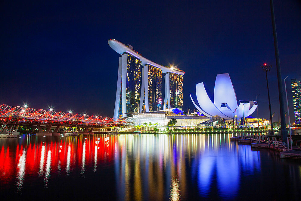 SINGAPORE, SINGAPORE - MARCH 2019: Skyline of Singapore Marina Bay at night with Marina Bay sands and Art Science museum reflecting in a pond after rain. Vibrant night scene