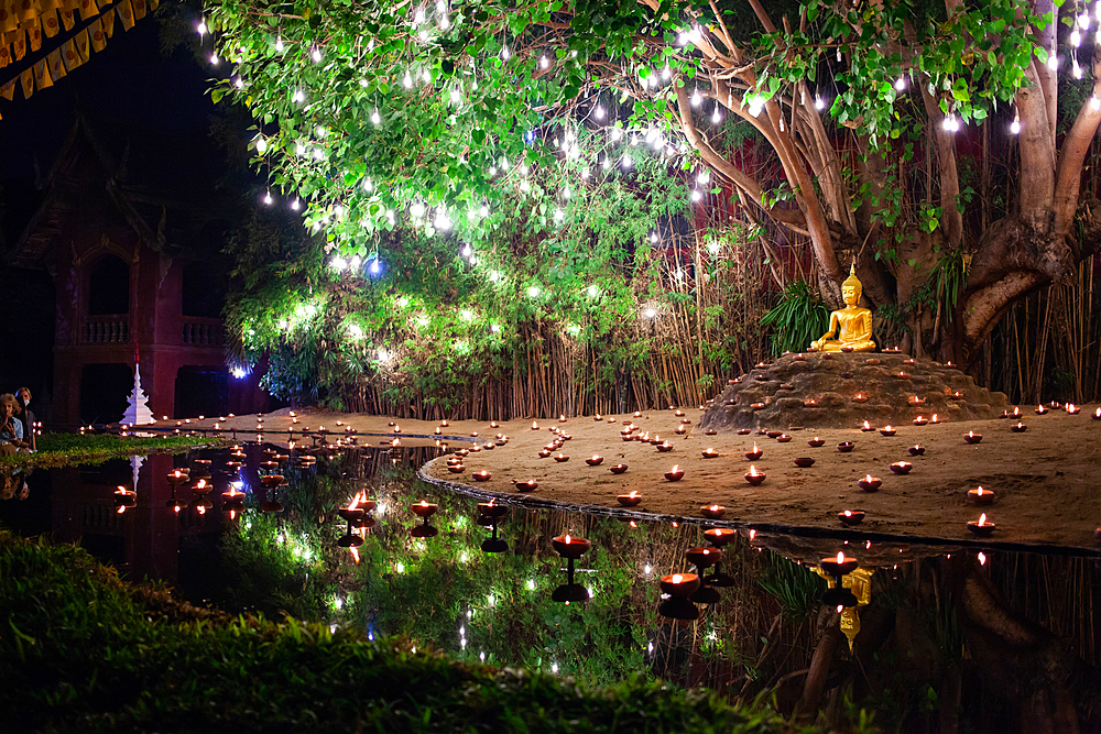 Makha bucha day celebrations in Chiangmai.Traditional monks pray under illuminated Buddha statue annually at Wat Phan Tao temple in Chiangmai,Thailand