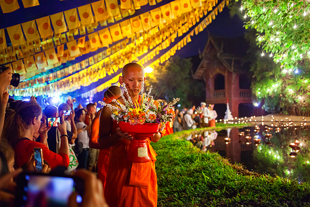 Makha bucha day celebrations in Chiangmai.Traditional monks pray under illuminated Buddha statue annually at Wat Phan Tao temple in Chiangmai,Thailand