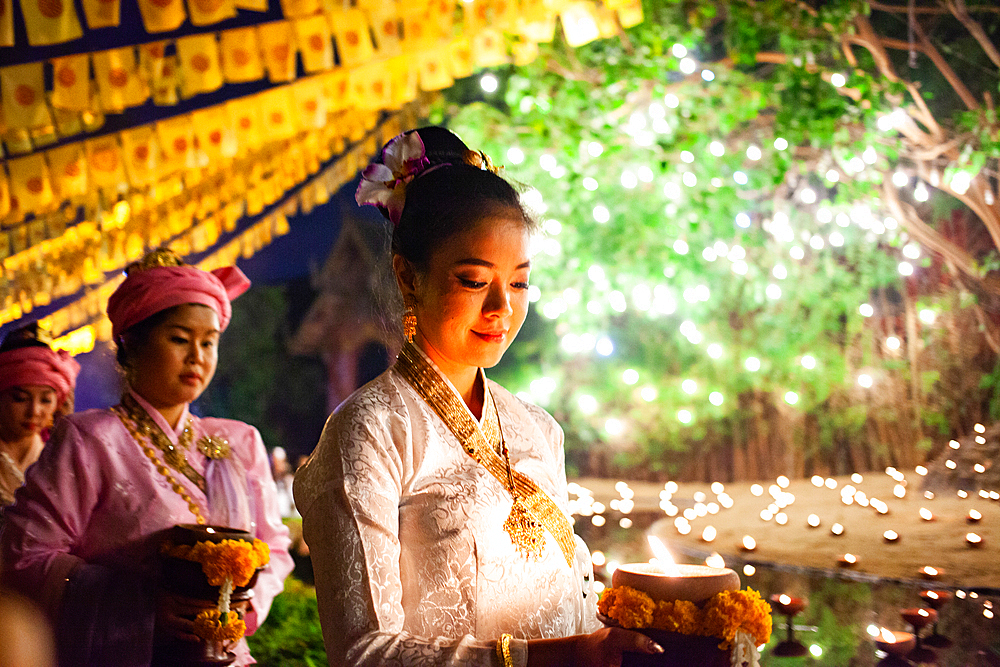 Makha bucha day celebrations in Chiangmai.Traditional monks pray under illuminated Buddha statue annually at Wat Phan Tao temple in Chiangmai,Thailand