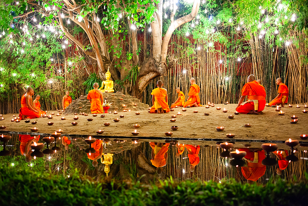 Makha bucha day celebrations in Chiangmai.Traditional monks pray under illuminated Buddha statue annually at Wat Phan Tao temple in Chiangmai,Thailand