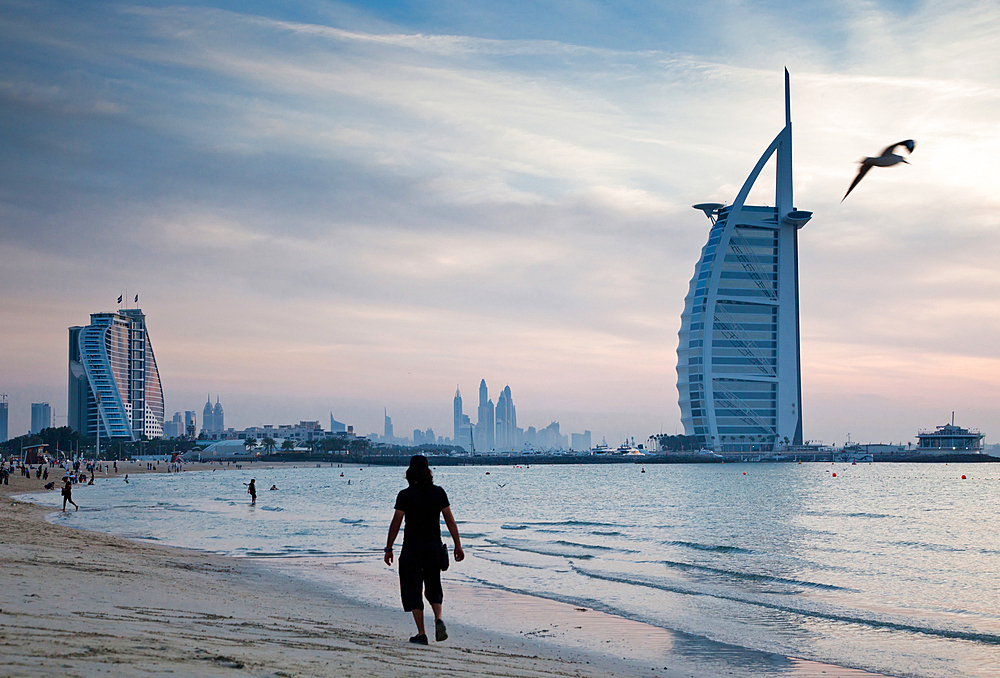 The world's first seven stars luxury hotel Burj Al Arab at sunset seen from Jumeirah public beach in Dubai, United Arab Emirates