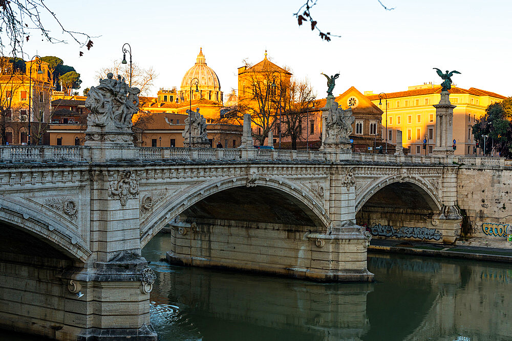 Sunrise hits the Vatican and St. Peter's Basilica but has not reached Vittorio Emanuele II bridge in the foreground, Rome, Lazio, Italy, Europe