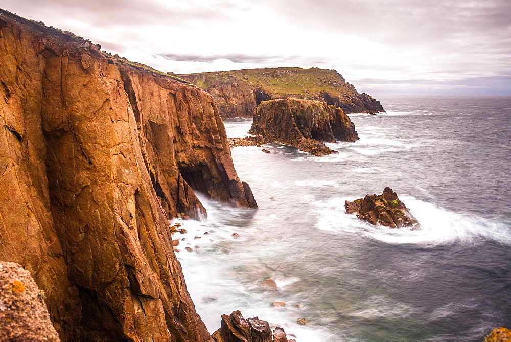 Coastal scenery with Enys Dodnan rock formation at Lands End, Cornwall, England, United Kingdom, Europe