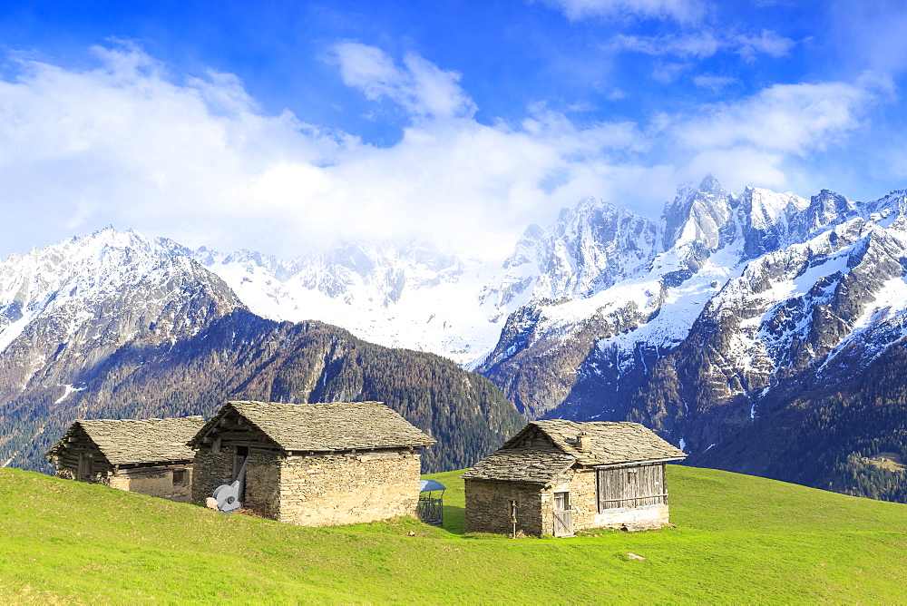 Traditional huts with Masino-Bregaglia group in the background, Soglio, Val Bregaglia, Graubunden, Switzerland, Europe