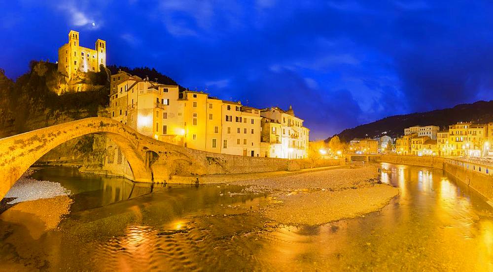 Lights reflected in the river during twilight, Dolceacqua, Province of Imperia, Liguria, Italy, Europe