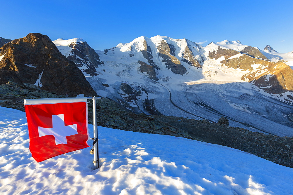 Swiss flag with Palu and Vedret Pers Glacier, Diavolezza Refuge, Bernina Pass, Engadine, Graubunden, Switzerland, Europe