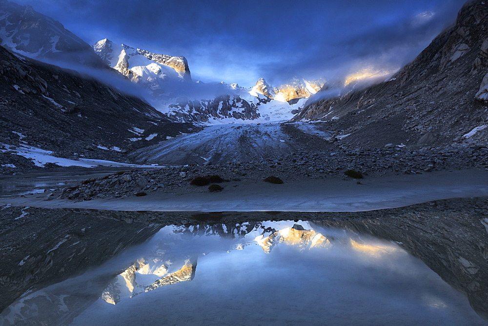 Forno Glacier reflected in a pond at foggy sunrise, Forno Valley, Maloja Pass, Engadine, Graubunden, Switzerland, Europe