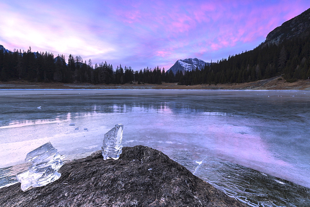 Colors of the sunset reflected on the icy surface of Lake Palu, Malenco Valley, Valtellina, Lombardy, Italy, Europe