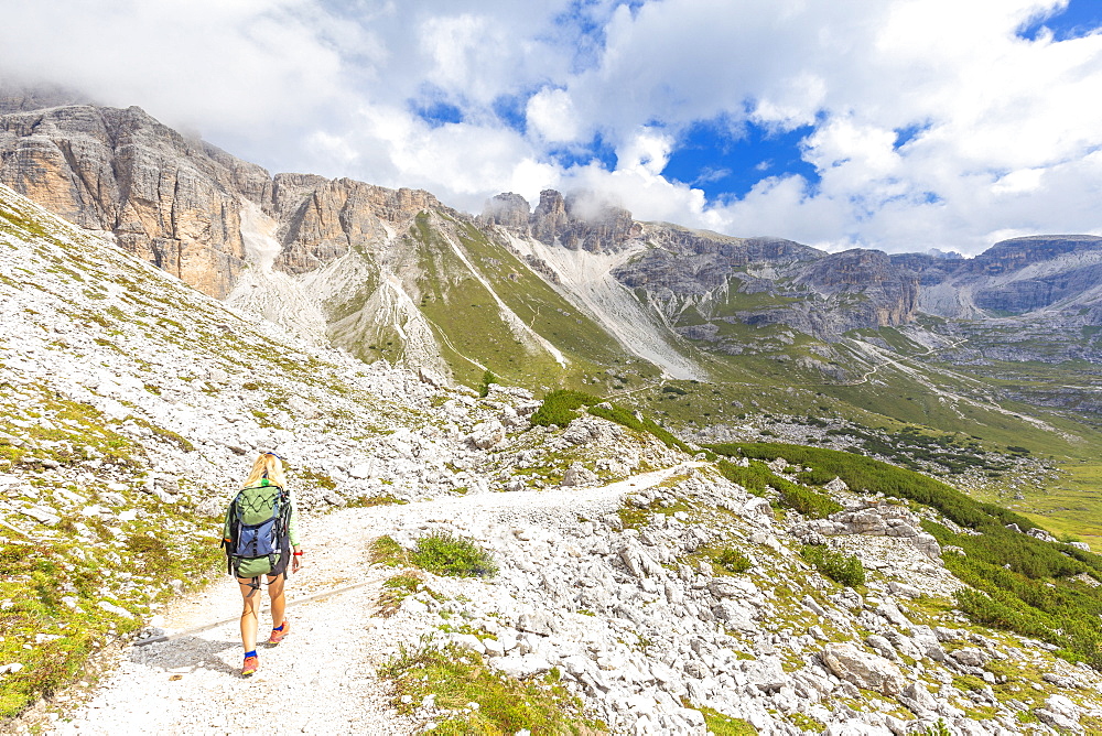 A hiker walks the path for Pian di Cengia Refug, Dolomites of Sesto (Sexten), Province of Belluno, Veneto, Italy, Europe