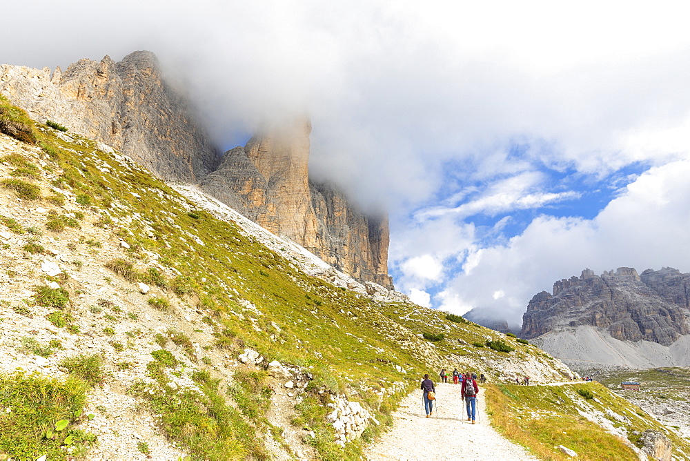 Tourists walks on the pathway for Three Peaks of Lavaredo, Dolomites of Sesto, Province of Belluno, Veneto, Italy, Europe