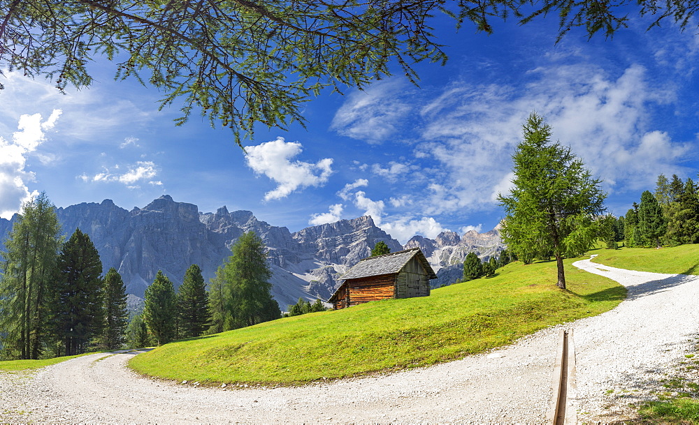 White track with traditional hut and Puez Group in the background, Longiaru, Badia Valley, South Tyrol, Dolomites, Italy, Europe