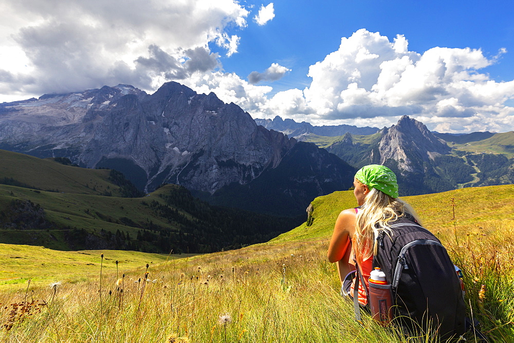 Girl looks towards Marmolada from Viel del Pan path, Pordoi Pass, Fassa Valley, Trentino, Dolomites, Italy, Europe