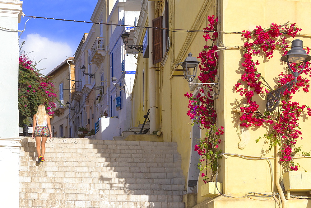 A tourist walks up steps at Carloforte, San Pietro Island, Sud Sardegna province, Sardinia, Italy, Mediterranean, Europe