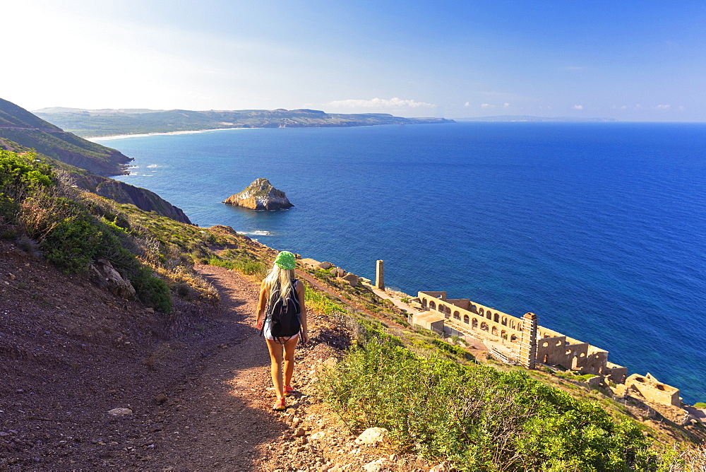 A girl walks on a path to Laveria Lamarmora, Nebida, Iglesias, Sud Sardegna province, Sardinia, Italy, Mediterranean, Europe