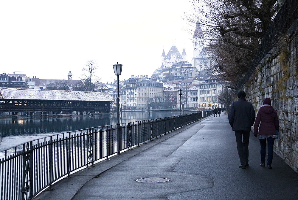 Two people walk along the river, Thun, Canton of Bern, Switzerland, Europe