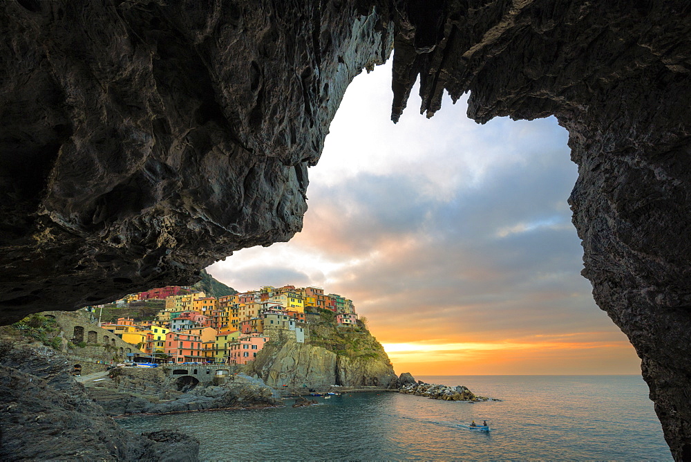 Sunrise on the village of Manarola from a sea cave, Cinque Terre, UNESCO World Heritage Site, Liguria, Italy, Europe