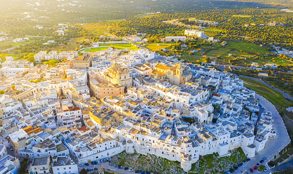 Aerial view by drone of the old town of Ostuni at sunset, Apulia, Italy, Europe