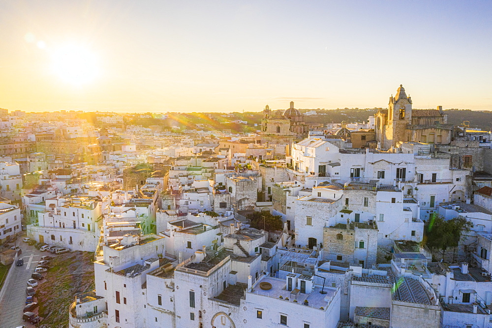 Aerial view by drone of the old town of Ostuni at sunset, Apulia, Italy, Europe