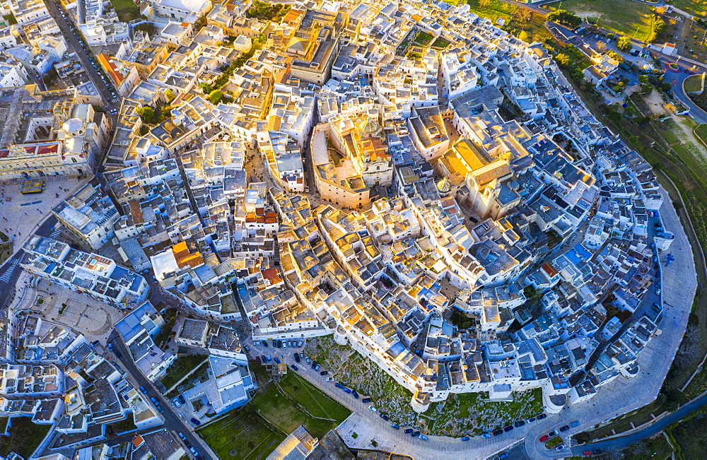 Zenithal aerial view of the old town of Ostuni at sunset, Apulia, Italy, Europe