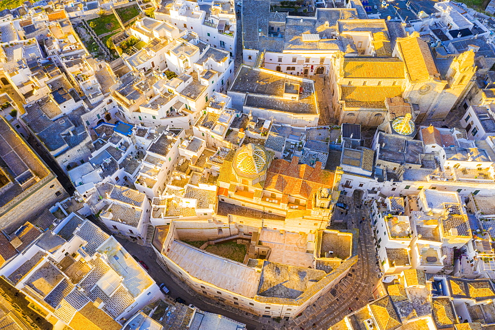 Zenithal aerial view of the old town of Ostuni at sunset, Apulia, Italy, Europe