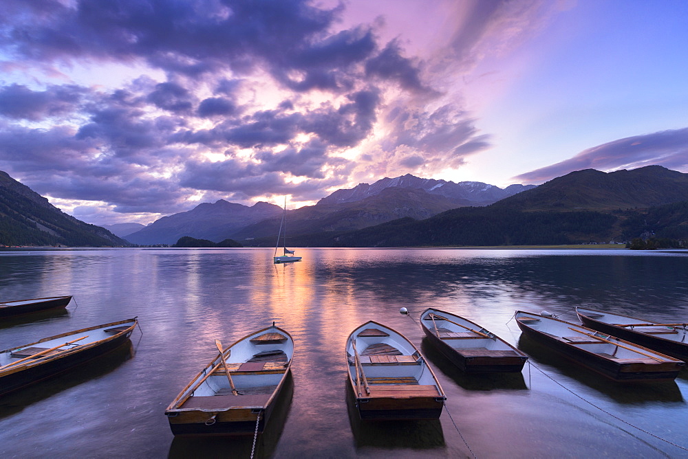 Moored boats in Lake of Sils at sunrise, Maloja Pass, Engadine valley, Graubunden, Switzerland, Europe