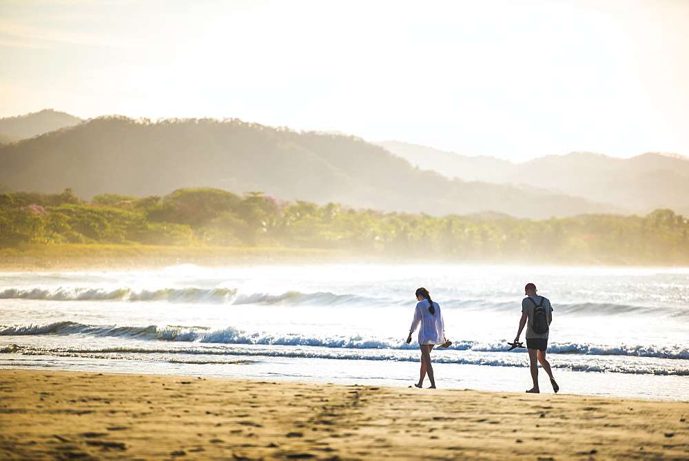 Couple on Playa Buena Vista Beach at sunrise, Guanacaste Province, Costa Rica, Central America